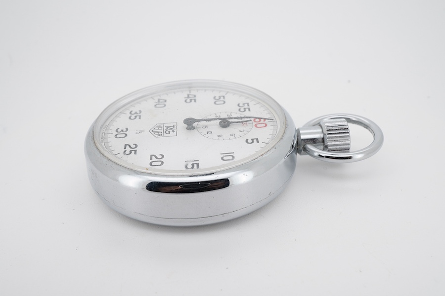 A chrome cased Tag Heuer stopwatch, the back with original red sticker, case diameter 50mm.